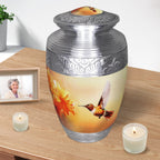 Yellow hummingbird urn with ornate silver edging, metal adult memorial vessel with candles for dear father