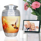 Elegant golden peach hummingbird metal funeral urn for ashes, intricate silver rim piece with blooms for mom and dad
