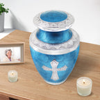 Urns for cremated remains displayed with candles, elegant tribute for mother featuring a Christian cross