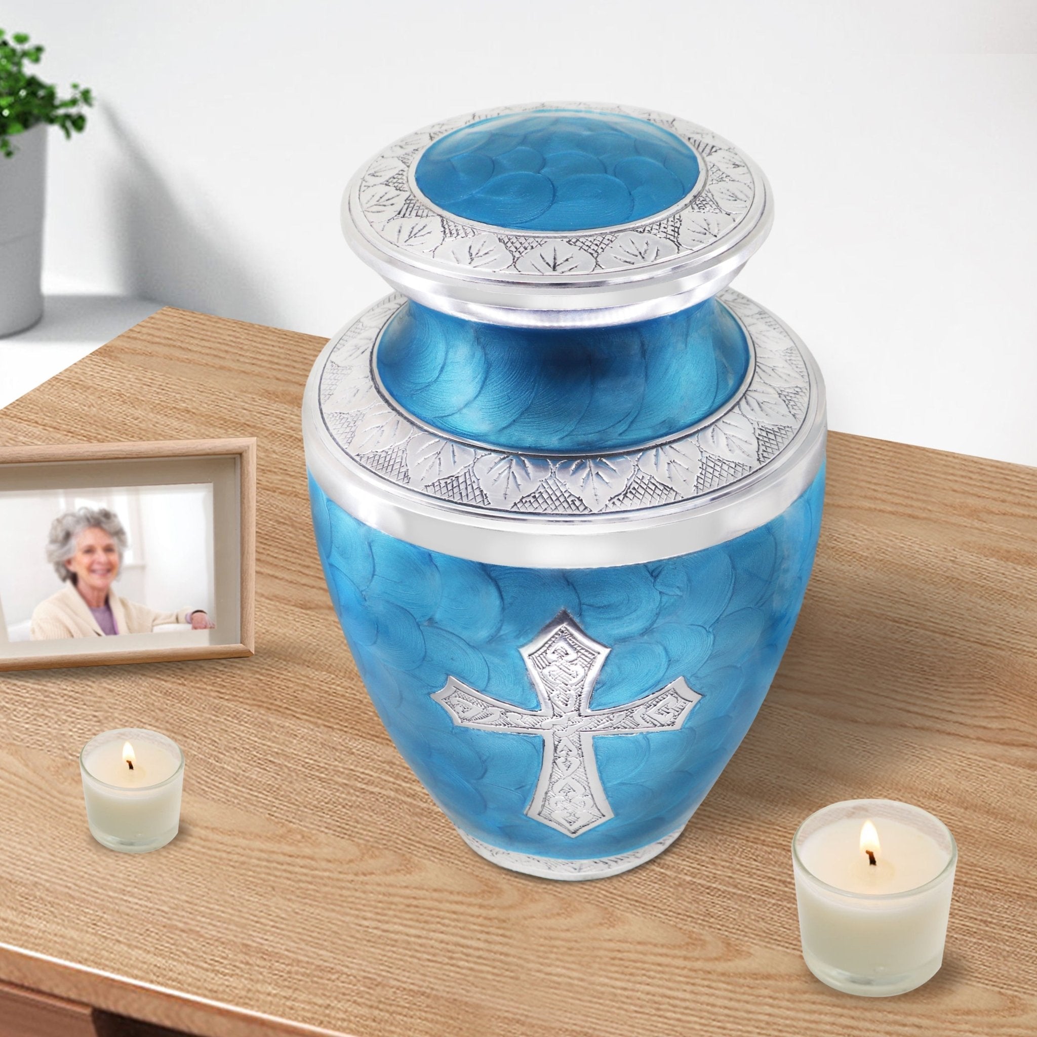 Urns for cremated remains displayed with candles, elegant tribute for mother featuring a Christian cross