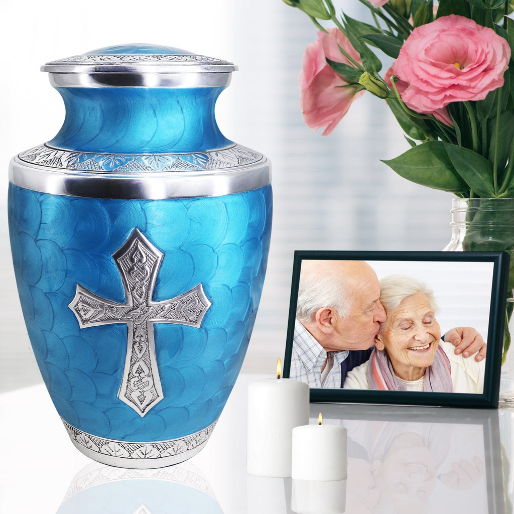 Urns for cremation ashes beside family photo and flowers, graceful keepsake for wife with engraved cross