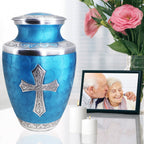 Urns for cremation ashes beside family photo and flowers, graceful keepsake for wife with engraved cross