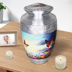 Silver aluminum vessel for crematorium use, butterfly sky teardrop adult urn displayed with table candles and framed photo
