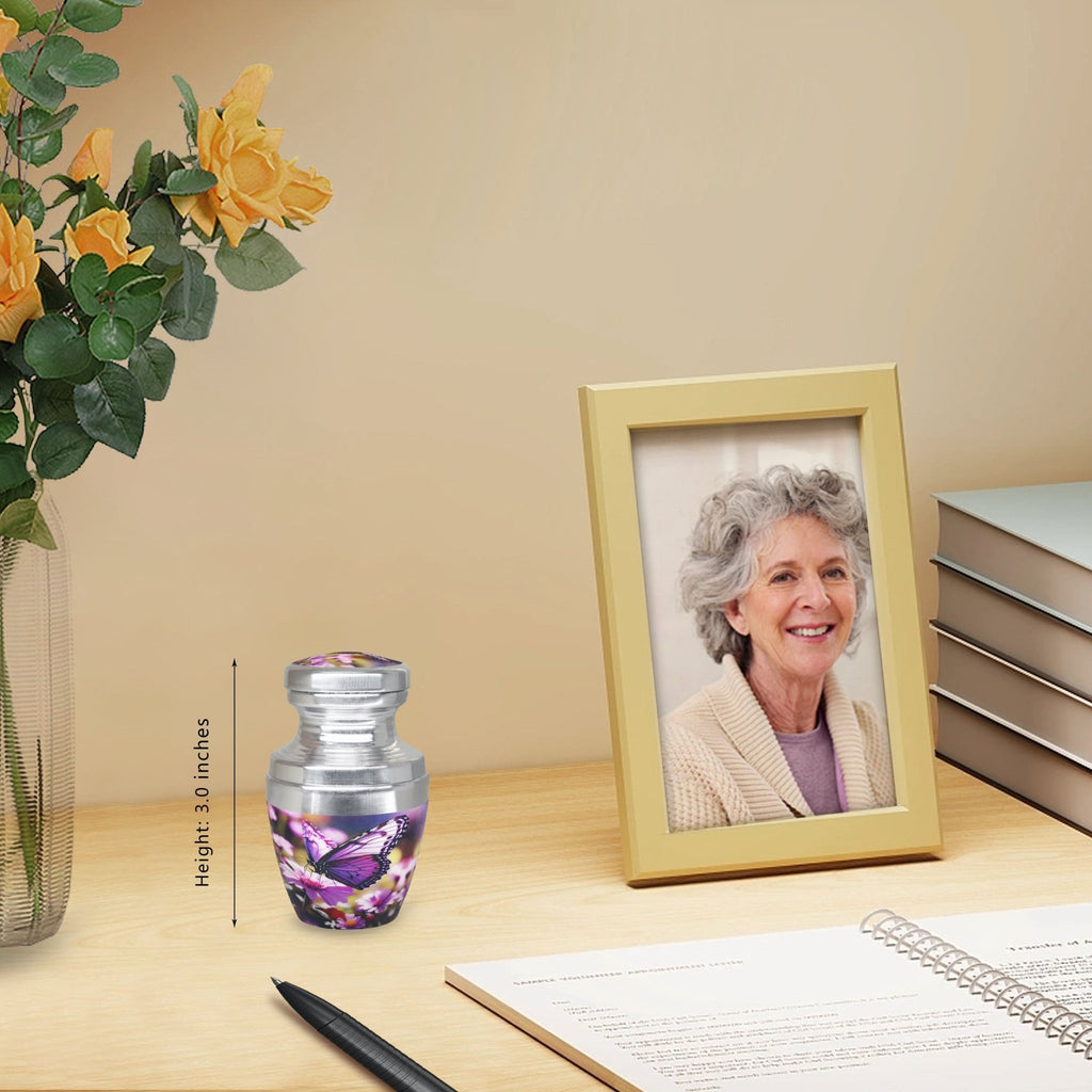 Tiny urns for ashes with purple butterfly flowers displayed near a family portrait for a treasured dad