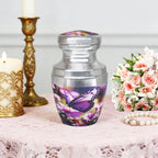Small urns for ashes with purple butterfly artwork beside candles and flowers, a peaceful tribute for father