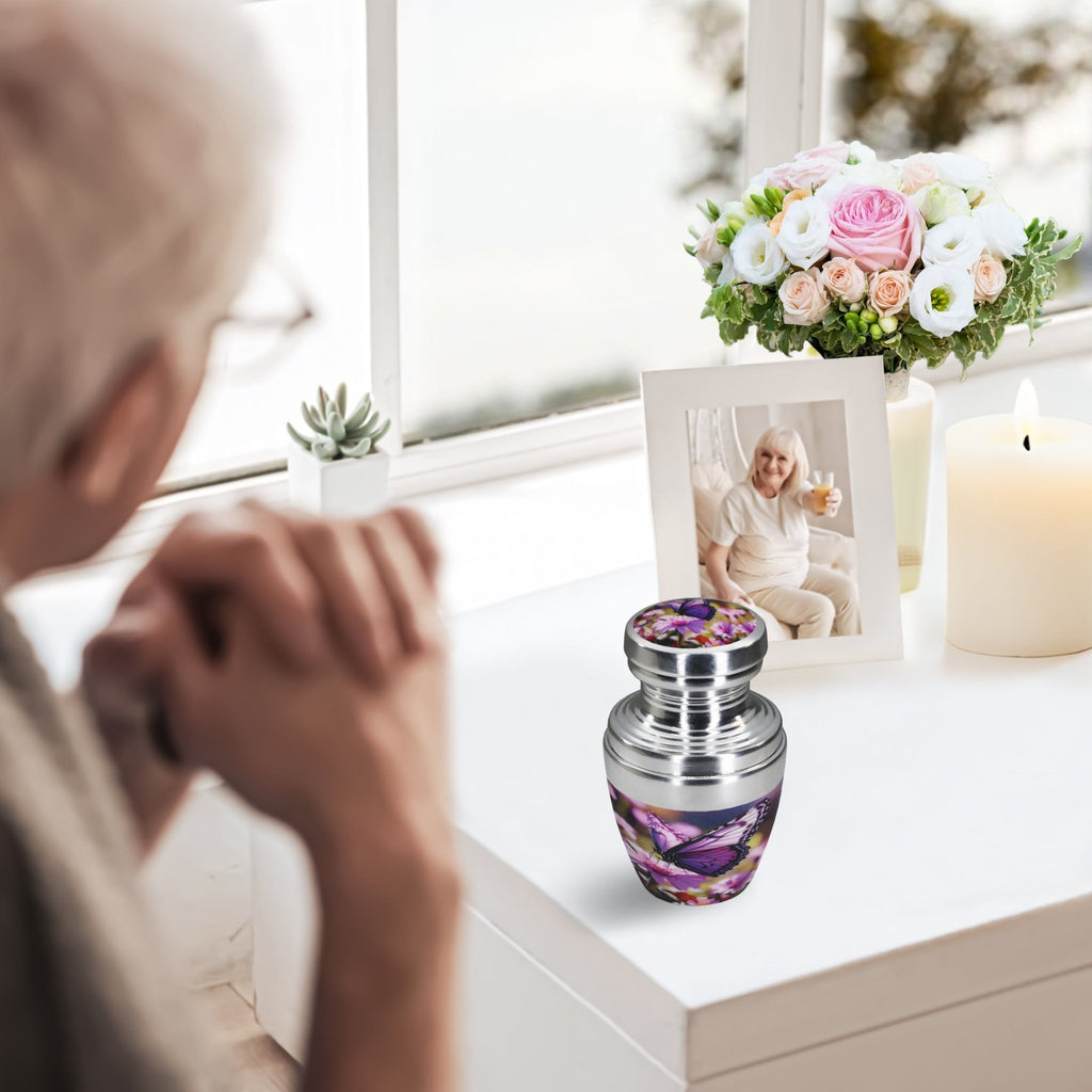 Purple cremation urns for human ashes, woman remembering her beloved husband by the window