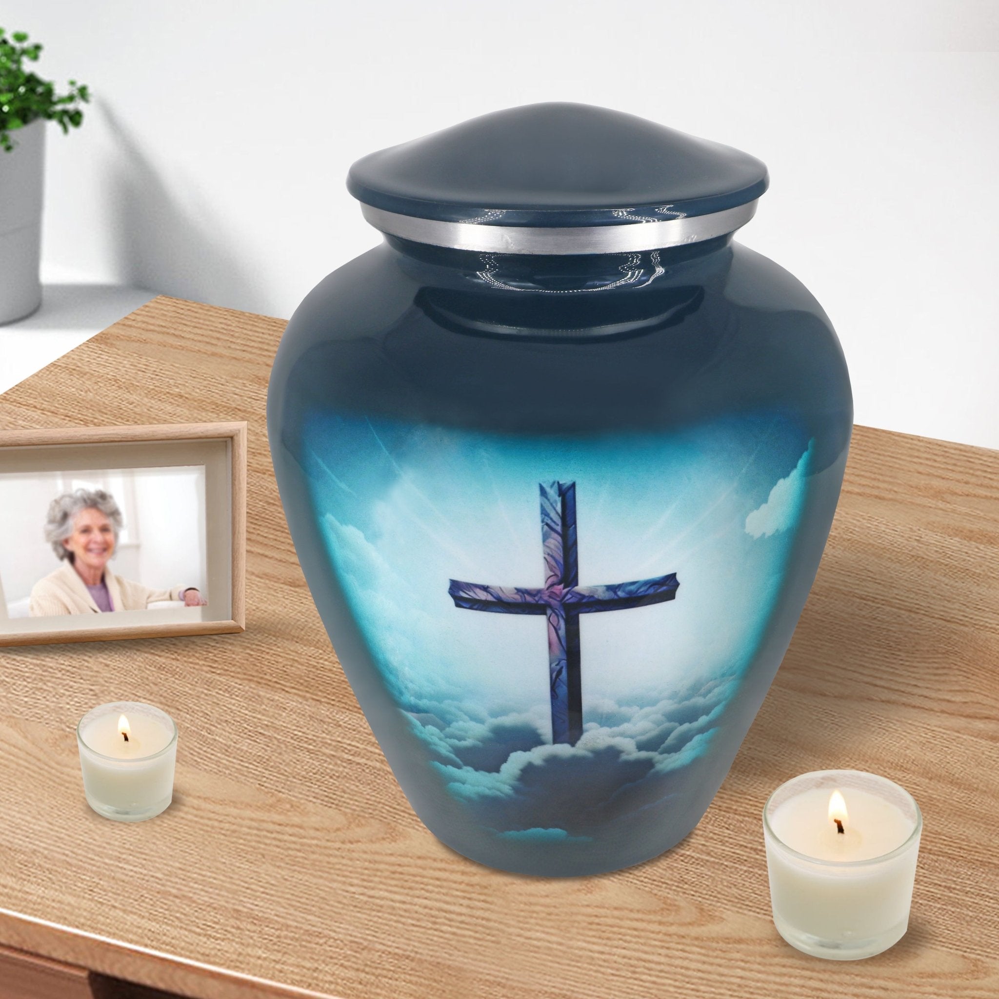 Christian urn for ashes with turquoise cross artwork displayed with candles for peaceful home remembrance