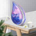 Big aluminum butterfly print cremation urn placed on wooden side table with candles for home memorial mantel decor
