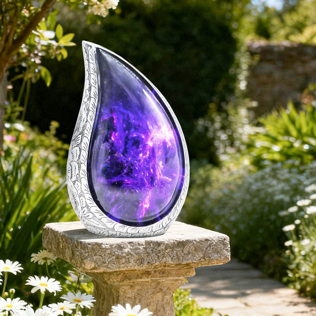 Purple cosmic galaxy burial urn displayed outdoors on a garden stone among green foliage