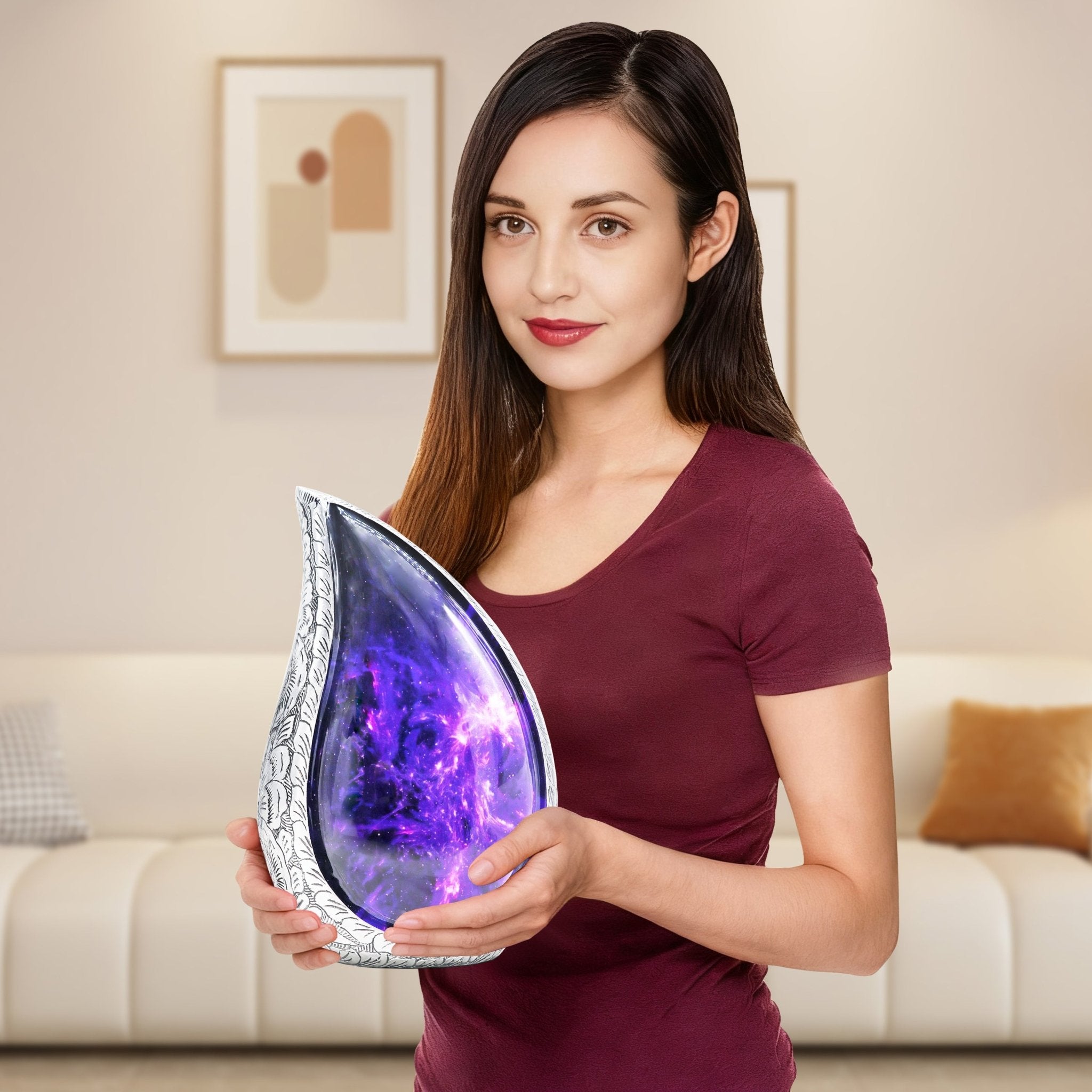 Woman holding a purple cosmic galaxy teardrop urn, showing the full-size adult memorial urn for scale