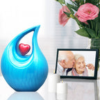 Turquoise heart shaped urn with white flowers and portrait photo, beautiful keepsake urns to celebrate a life