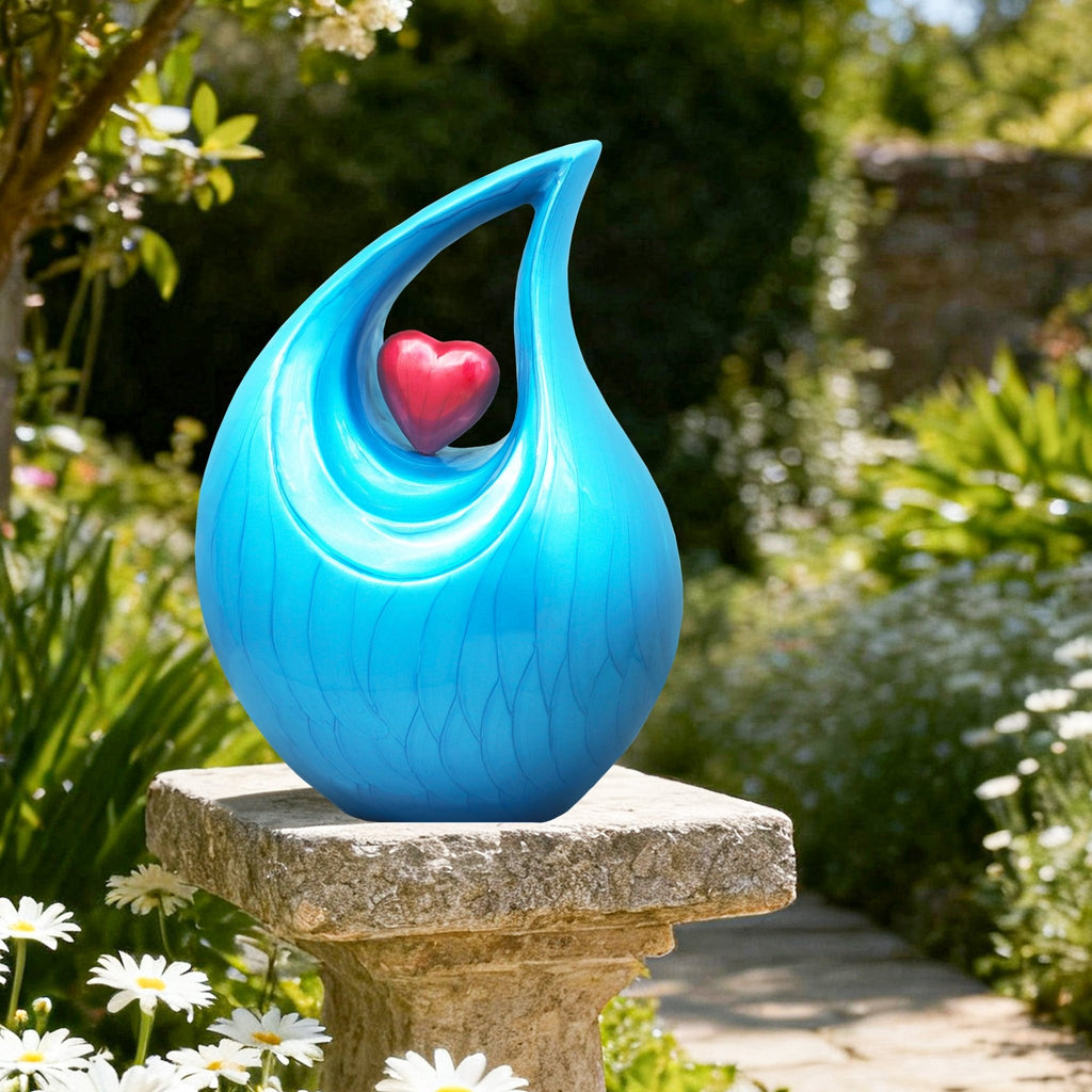Blue memorial urn set among green garden plants, serene outdoor burial urn for peaceful backyard memorial placement