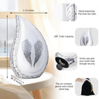 Large size chart of white engraved angel wings ashes in an urn aluminum teardrop with silver trim and accessorie