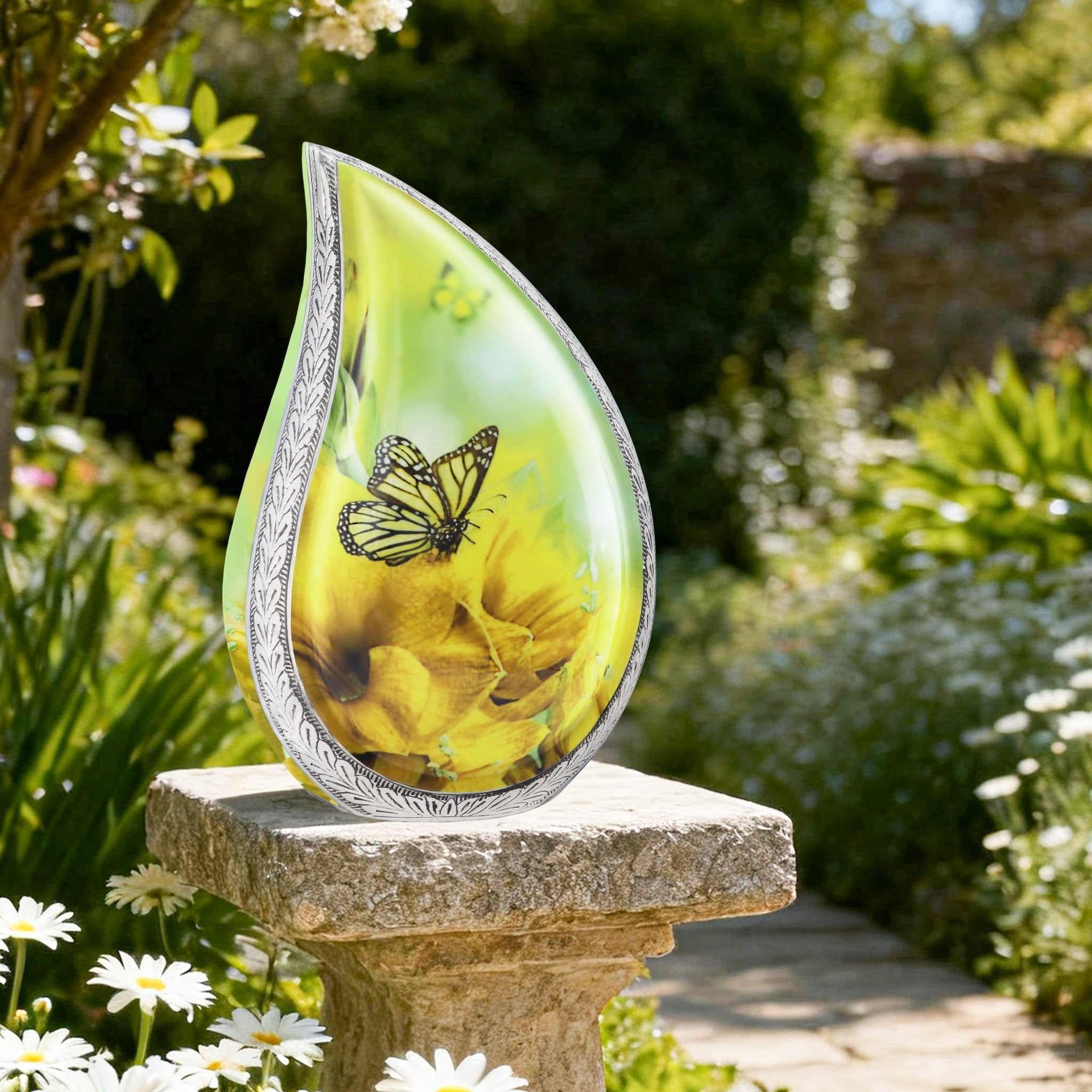 Elegant yellow floral butterfly funeral urn resting on stone garden pillar for peaceful outdoor cemetery remembrance