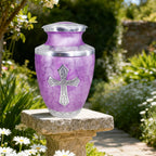 Urns for cremation ashes in a serene garden, engraved cross design honoring a loved one with timeless dignity