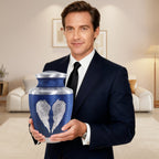 Big blue intricately engraved angel design urns for ashes for adults male for loved one, held by man for clear size reference