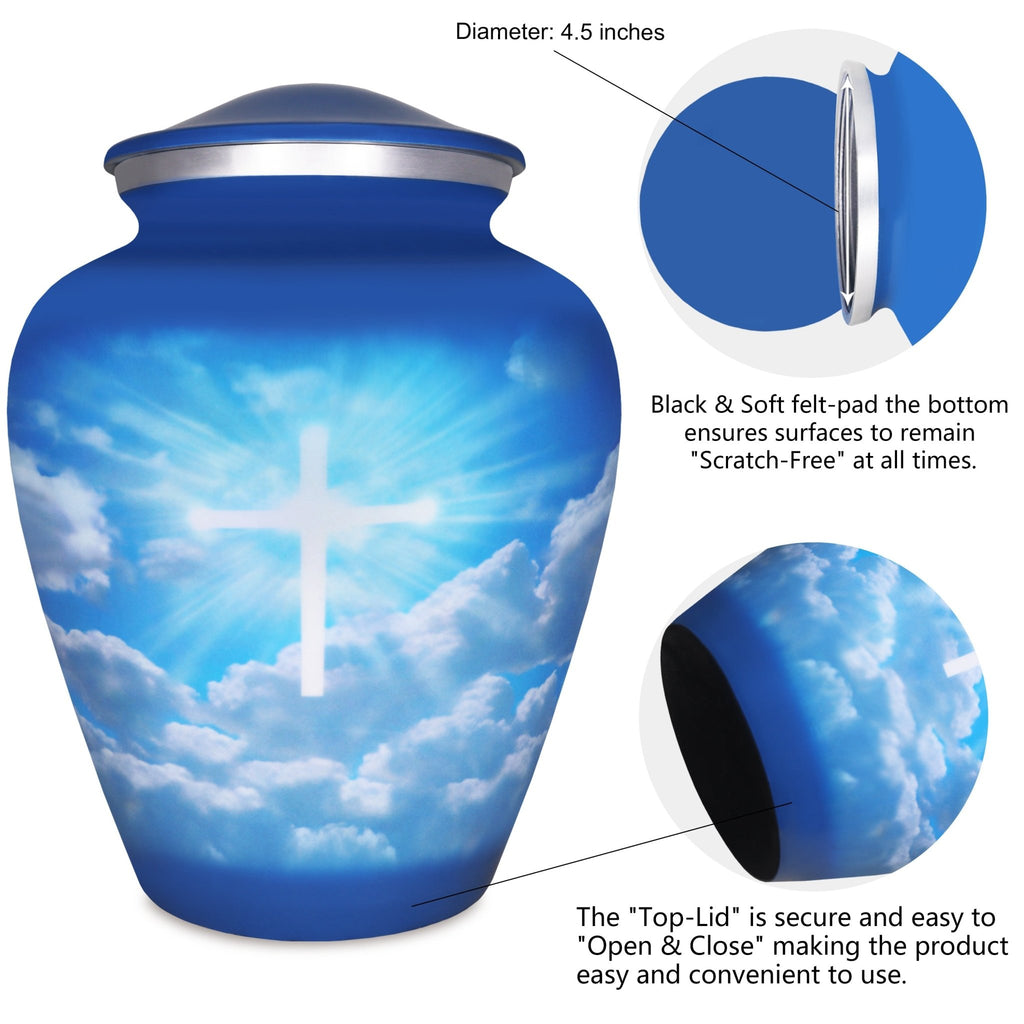 Metal cremation urn with luminous cross and cloud artwork, secure threaded top lid shown in detailed close-up