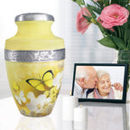 Butterfly urns for human ashes beside family photo and roses, graceful memorial for wife and cherished memories