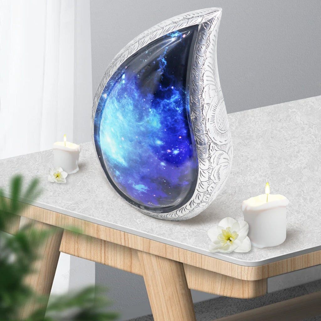 Beautiful aurora borealis urn displayed on wooden living room table with candle, decorative cremation urns for home mantel