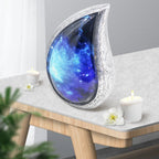 Beautiful aurora borealis urn displayed on wooden living room table with candle, decorative cremation urns for home mantel