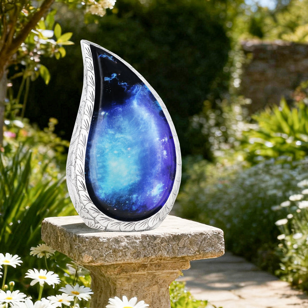 Stunning north lights teardrop urn resting on stone pillar in garden, peaceful outdoor burial memorial for cemetery placement