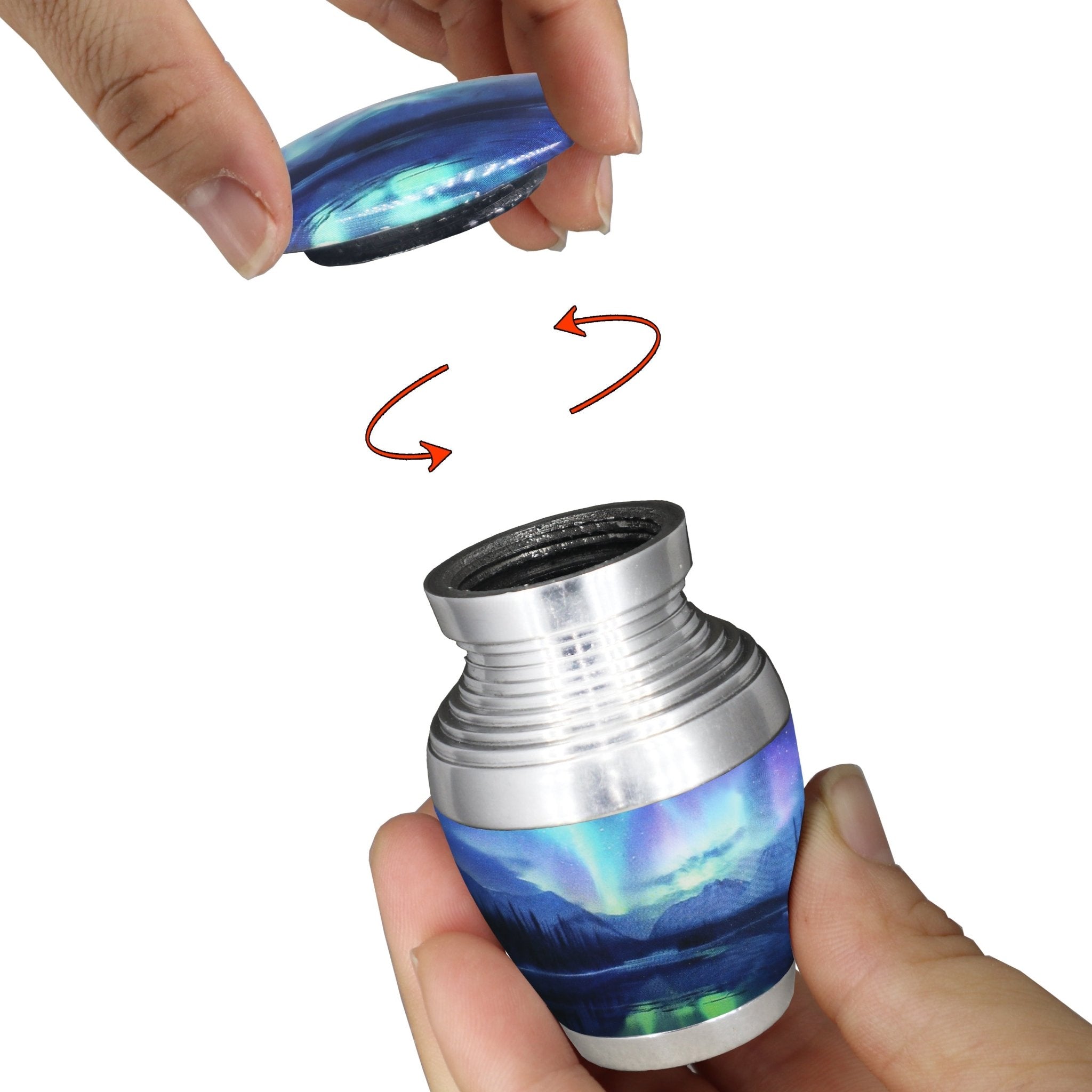 Mini urn for ashes with Northern Lights artwork and secure threaded screw-top lid shown opened by hand