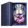 Keepsake urn for ashes with purple butterfly floral artwork presented in a padded blue memorial gift box