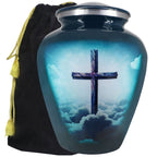 Cross urn for ashes in turquoise with blue cloud artwork, adult aluminum memorial urn and black velvet storage bag
