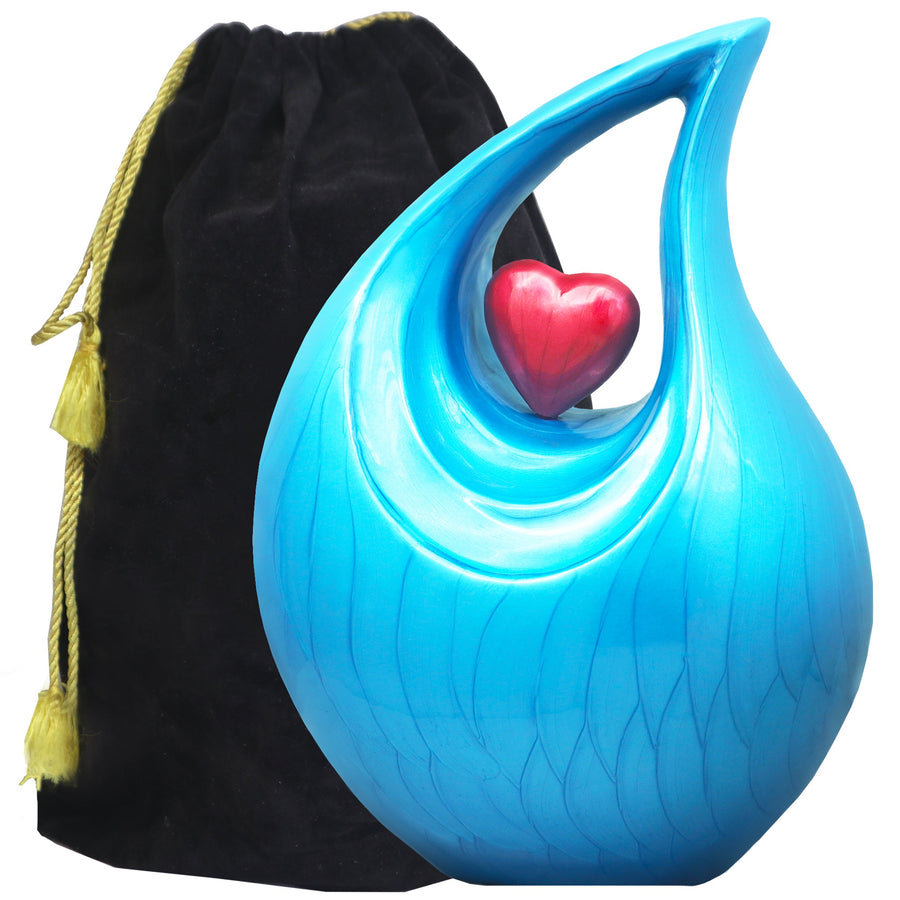 Heart urn in turquoise blue with sculptural tear drop design, red heart center and black velvet storage bag for remembrance