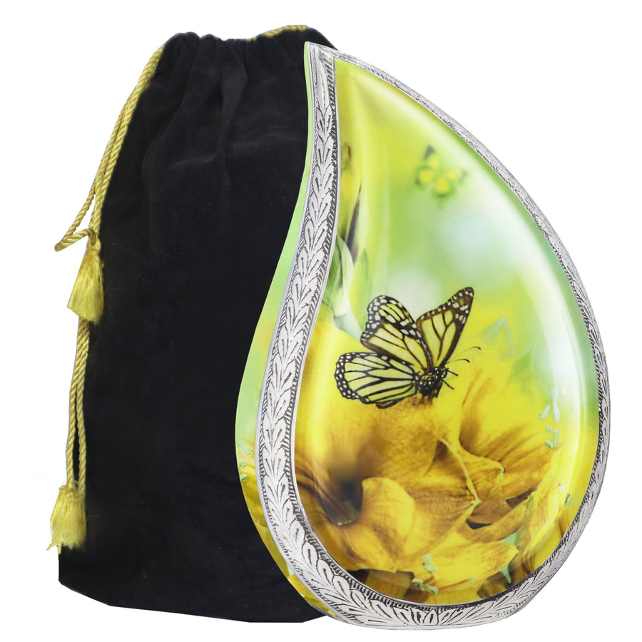 Yellow butterfly urn for ashes in teardrop shape with engraved silver trim and black velvet storage bag