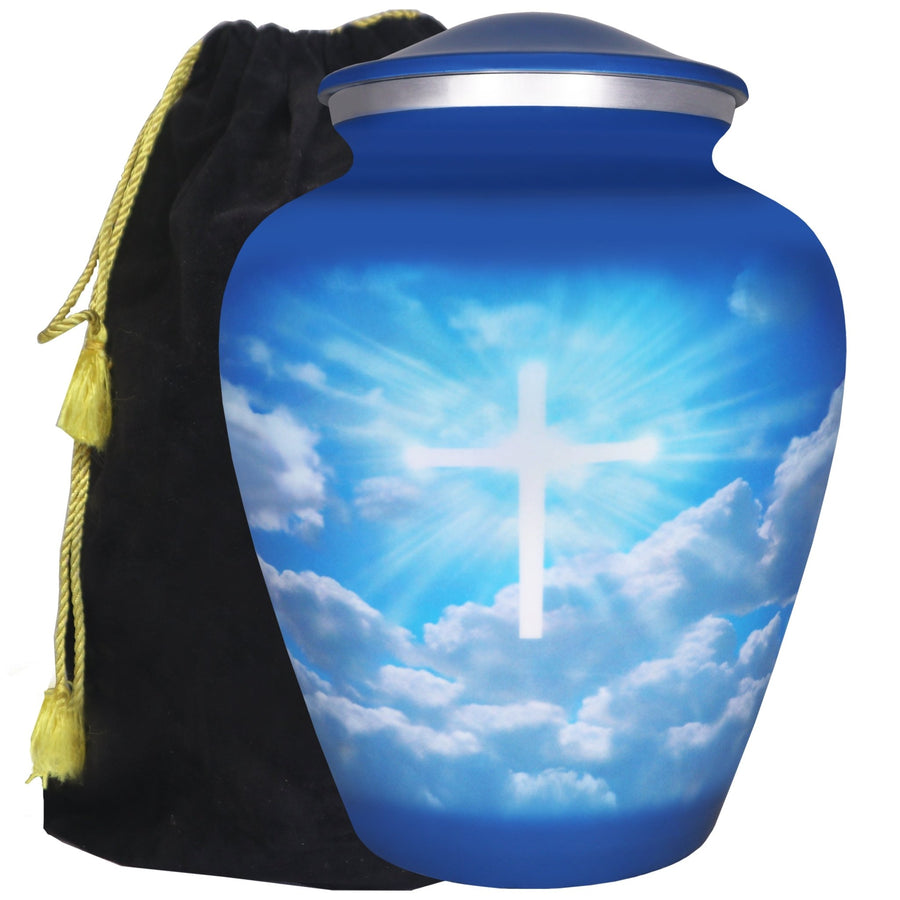 Blue urn for ashes with luminous Christian cross, blue sky and white cloud artwork, adult aluminum urn with velvet bag