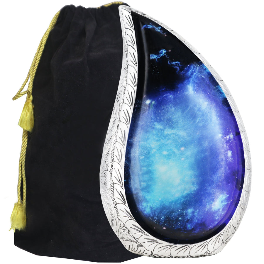 Black and blue galaxy urn with cosmic tear drop artwork, engraved silver trim and a black velvet storage bag