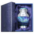 Mini keepsake urn for ashes with Aurora Borealis artwork presented in a padded blue memorial gift box