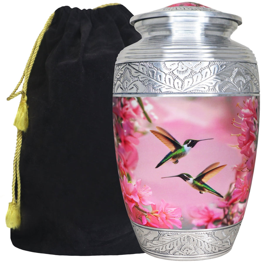 Pink hummingbird urn for ashes with floral artwork, silver engraved bands and black velvet storage bag