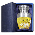 Keepsake urn for ashes with yellow butterflies and flowers presented in a padded blue memorial gift box