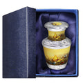 Keepsake urn for ashes with yellow butterfly artwork presented in a padded blue gift box