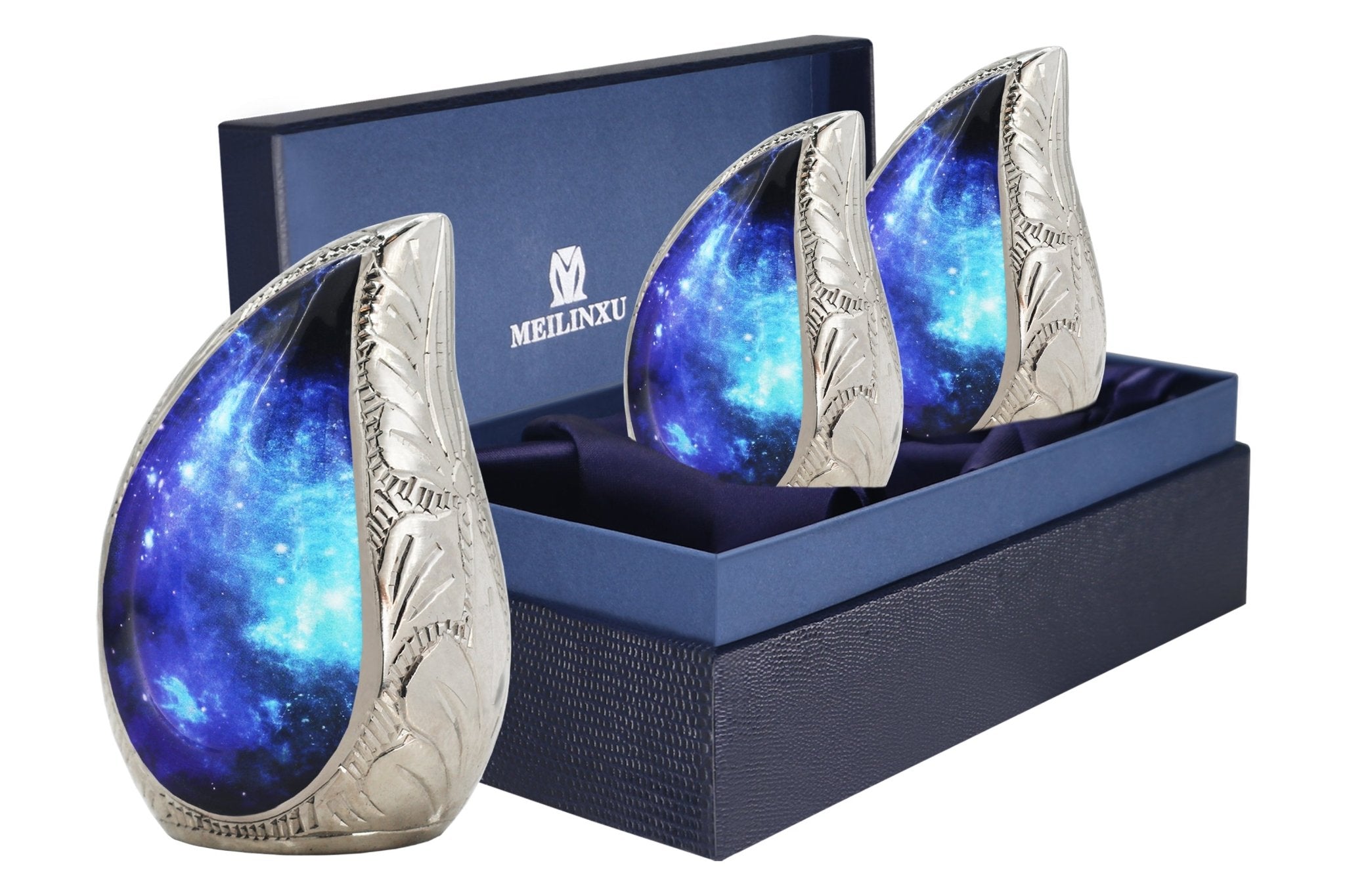 Set of three blue cosmic galaxy brass teardrop mini cremation urns packaged inside premium dark navy memorial gift box