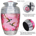 Aluminum urn for cremated remains with pink hummingbird artwork and secure threaded top lid shown in close-up
