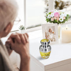 Cremation urns for human ashes with butterfly blooms, woman remembering her beloved husband by the window