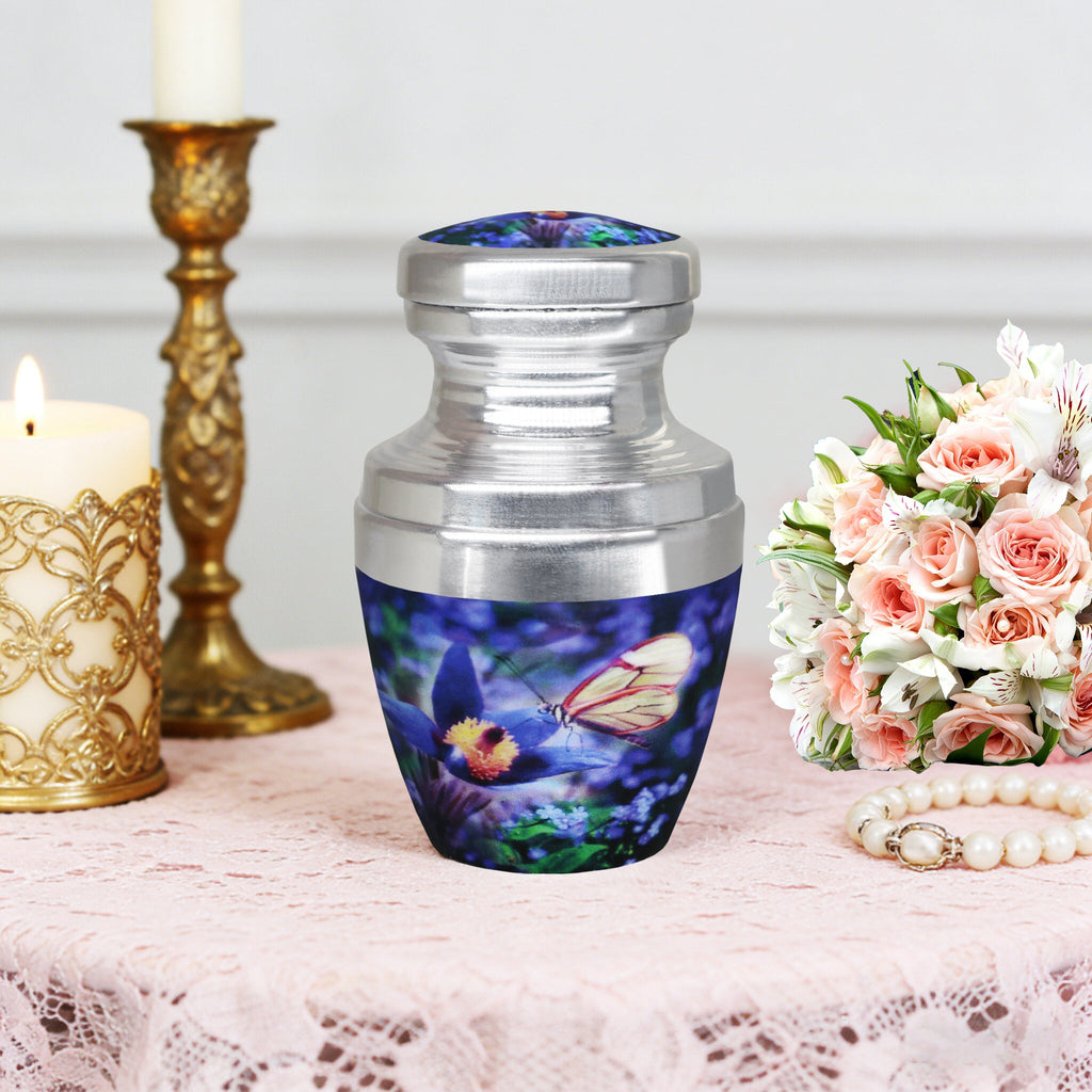 Small urns for ashes with blue butterfly flowers beside candles, a peaceful tribute for a loving father