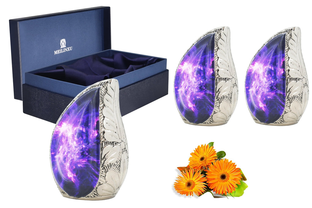 Cosmic galaxy ashes keepsake set with three purple brass mini urns, blue presentation box and orange flowers