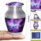 Miniature urn for ashes with purple nebula artwork, compact 3-inch size and secure screw-top lid shown in hand