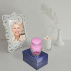Miniature urns for ashes displayed beside a memorial portrait, a baby urn remembering a precious child