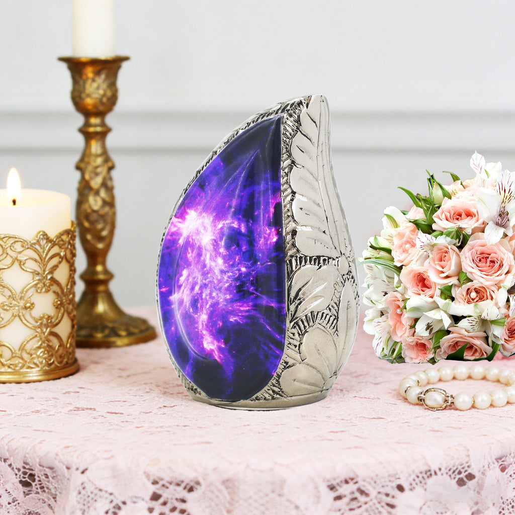 Ornate purple cosmic teardrop brass small urn arranged with candlesticks and roses for elegant funeral table decor