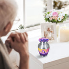 Small urns for human ashes with lavender butterfly design, tiny keepsake urn on windowsill, senior lady mourning by memorial