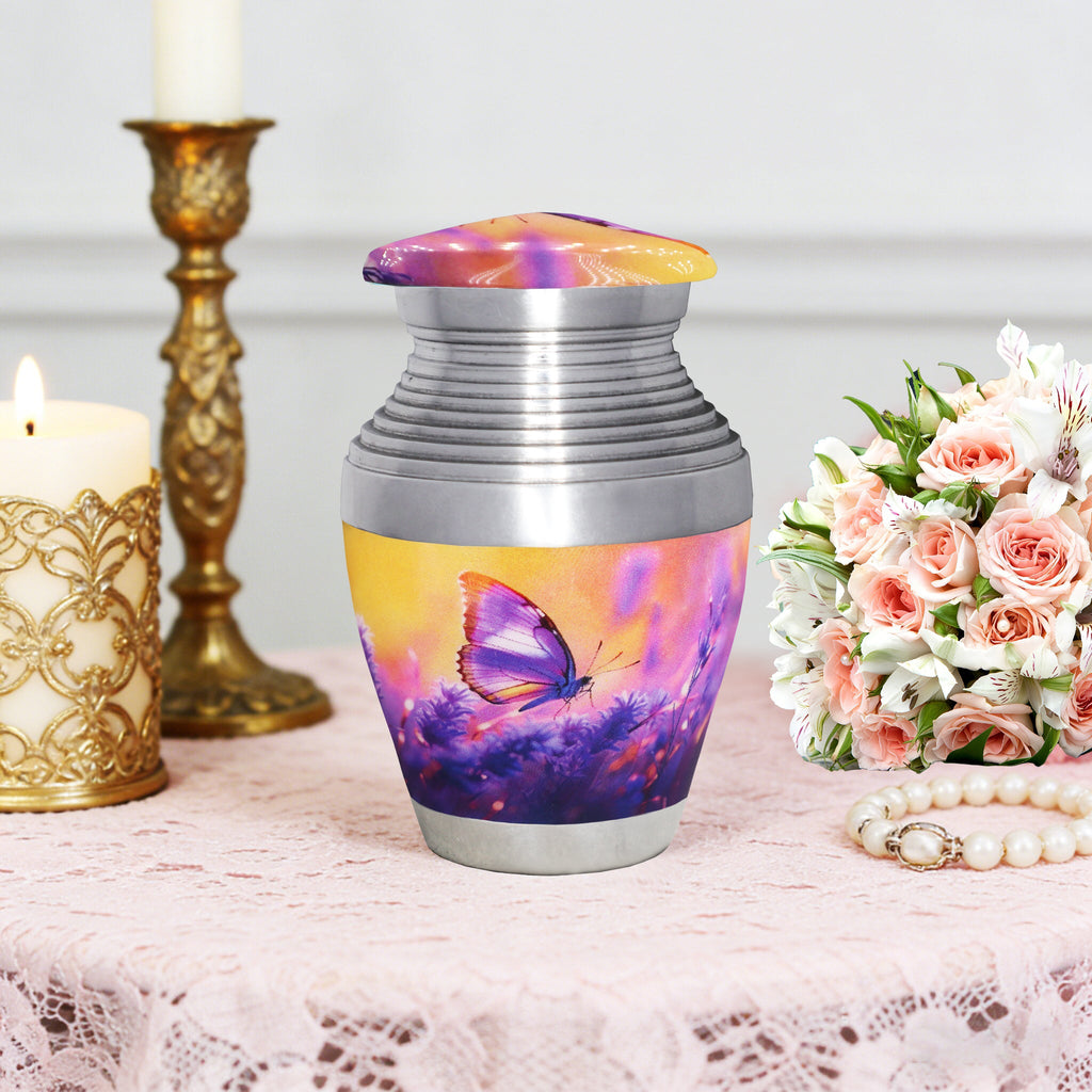 Cremation containers with purple lavender butterflies pattern, small memorial urn, table display with flowers and candle