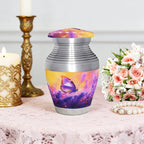 Cremation containers with purple lavender butterflies pattern, small memorial urn, table display with flowers and candle