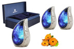Product bundle flat view, set of 3 blue starry brass teardrop keepsake urns packaged in premium dark gift box