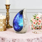 Table decor front view, blue nebula engraved brass miniature ash urn styled with florals for funeral tribute display