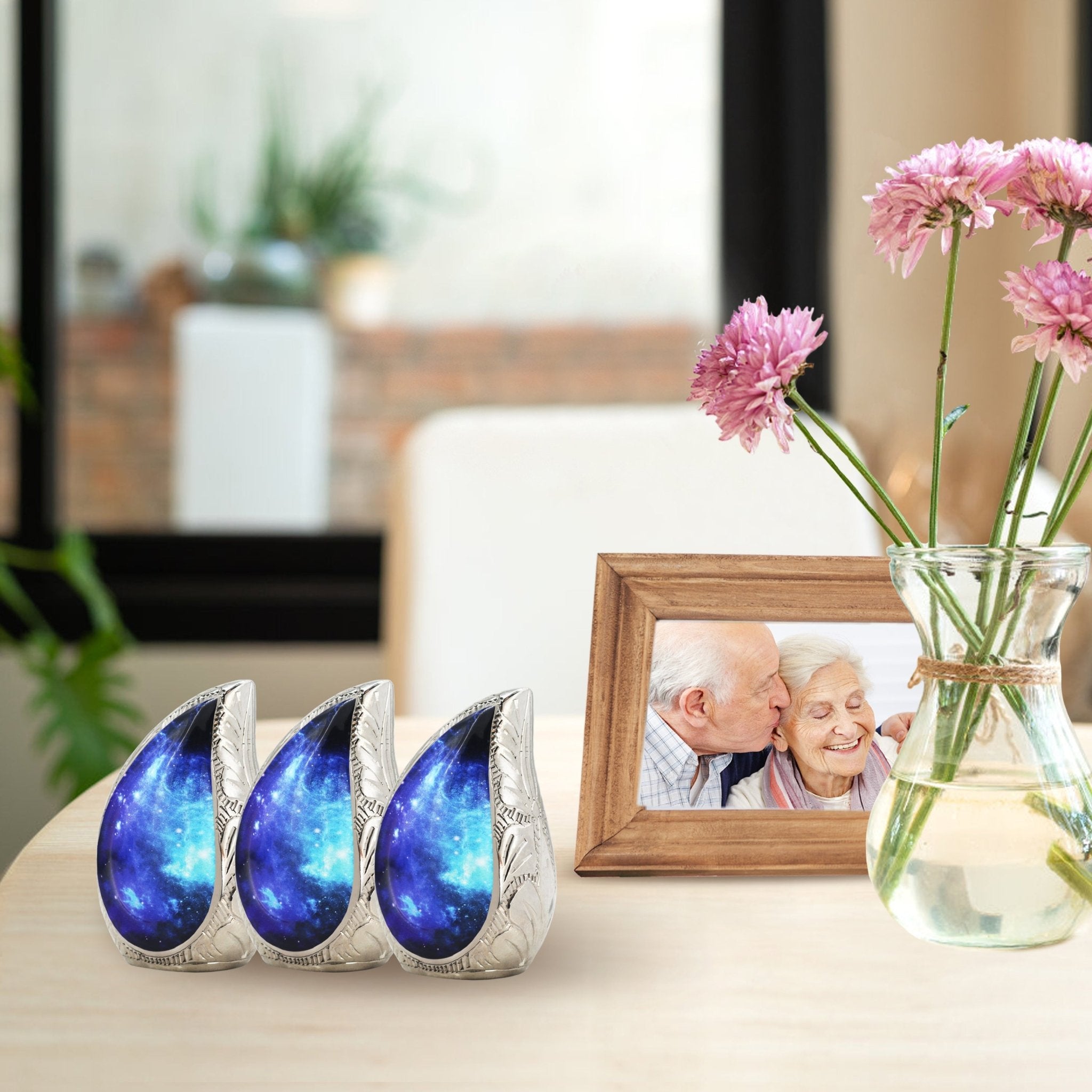 Three matching blue cosmic engraved brass small ash urns grouped on living room shelf for shared family ashes